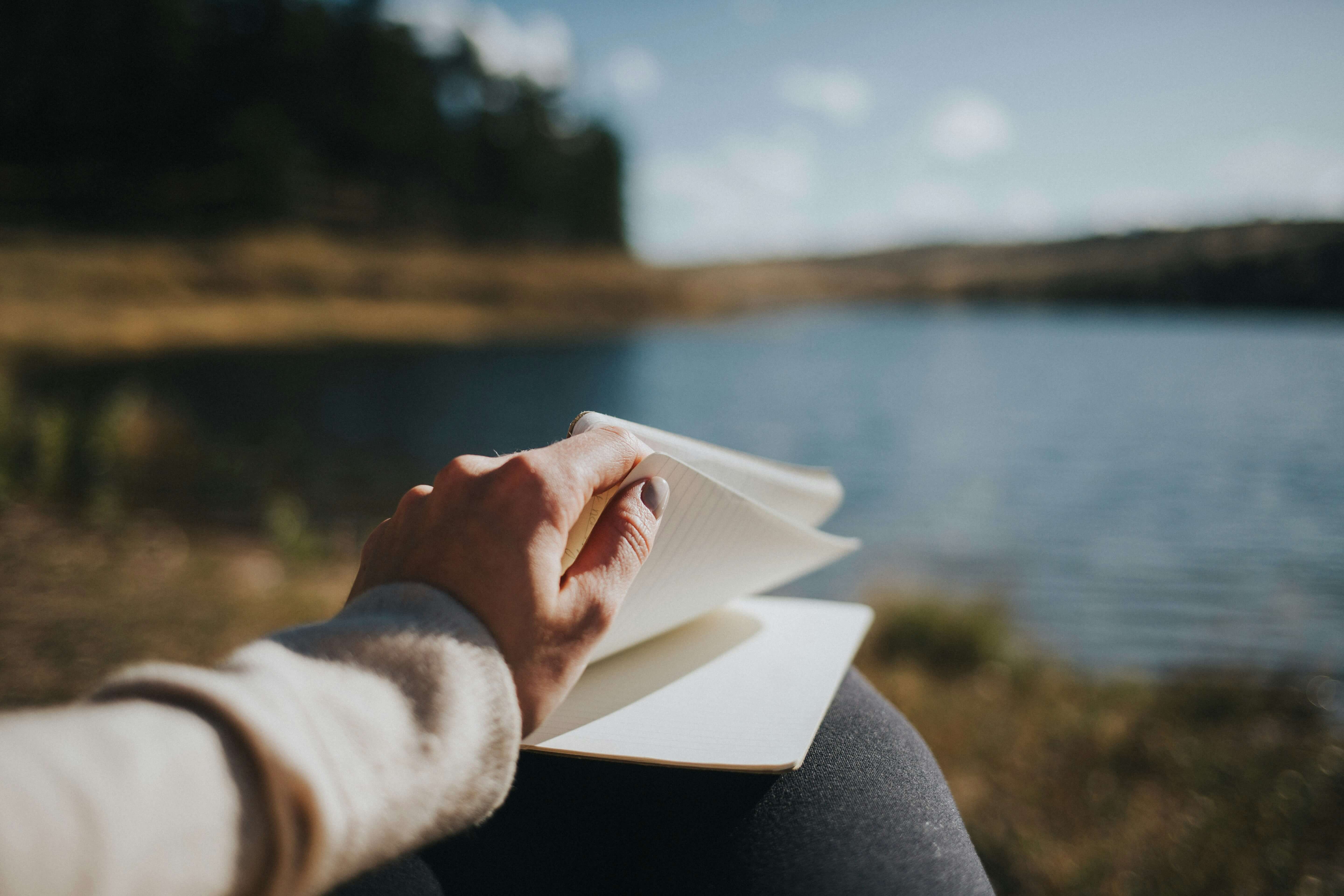 Sitting by the water reading a book